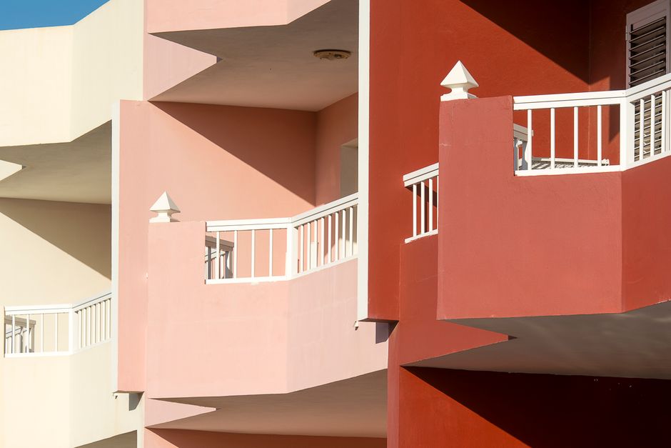 Painted exterior walls and balconies in several colours.